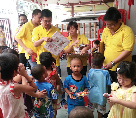 FLD volunteers sharing supplies with children